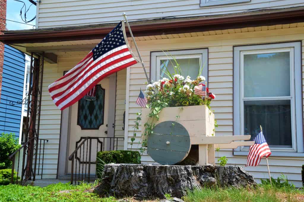 CELEBRATING AMERICA A cart of red and white geraniums bloom in the front of Gene and Arlene Decareau_s home-2