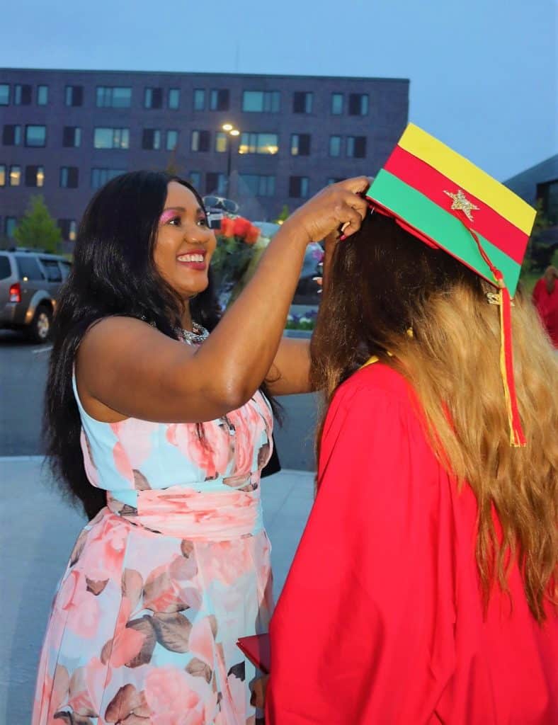 THAT_S MY DAUGHTER Linda Kembo, beams a smile of pride at last Friday night_s Saugus High graduation ceremony, as she adjusts the hat of her daughter, Crystal Fosung Kembo, one of the new graduates