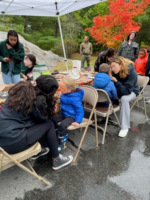 The face-painting table run by Revere High School students