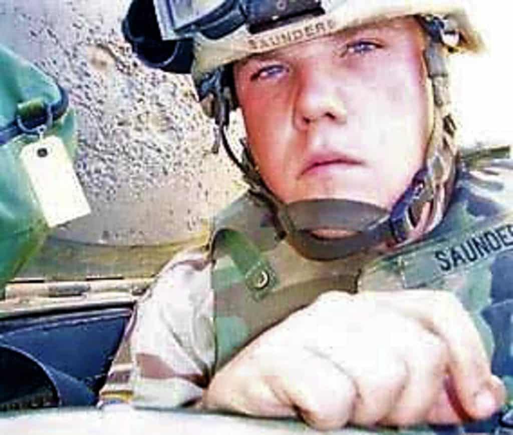 IN THE GUNNER’S HATCH Michael Saunders as a U.S. Army combat engineer in Iraq in 2005
