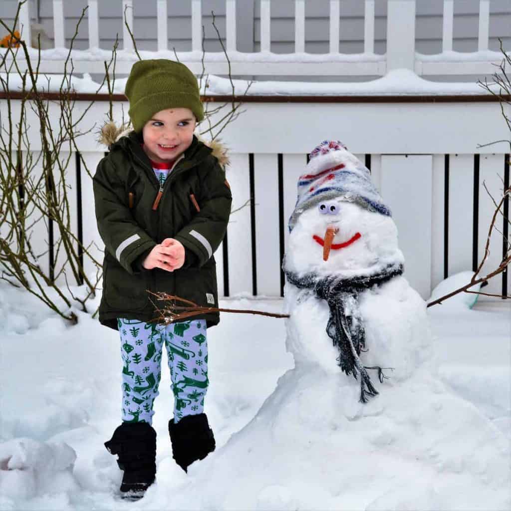 A FUN WINTER DAY Three-year old Cole Mangan built a happy snowman on Cleveland Avenue-2