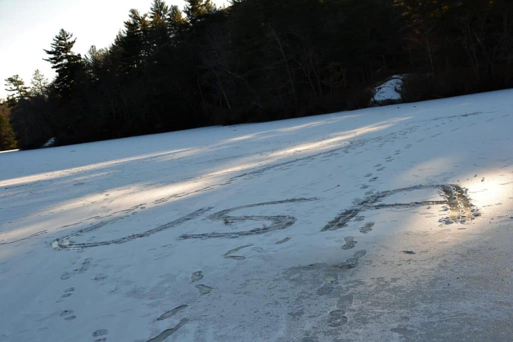 THE OLYMPIC SPIRIT PREVAILS Someone created a message cheering on Team USA in boot prints on Pearce Lake in Breakheart Reservation-2