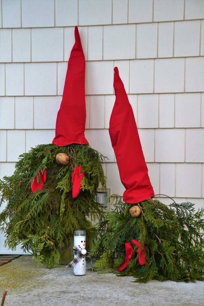 WELCOME GUESTS Gnomes made by Lorraine DiMilla from greens cut in her garden greet neighbors on her front porch-2