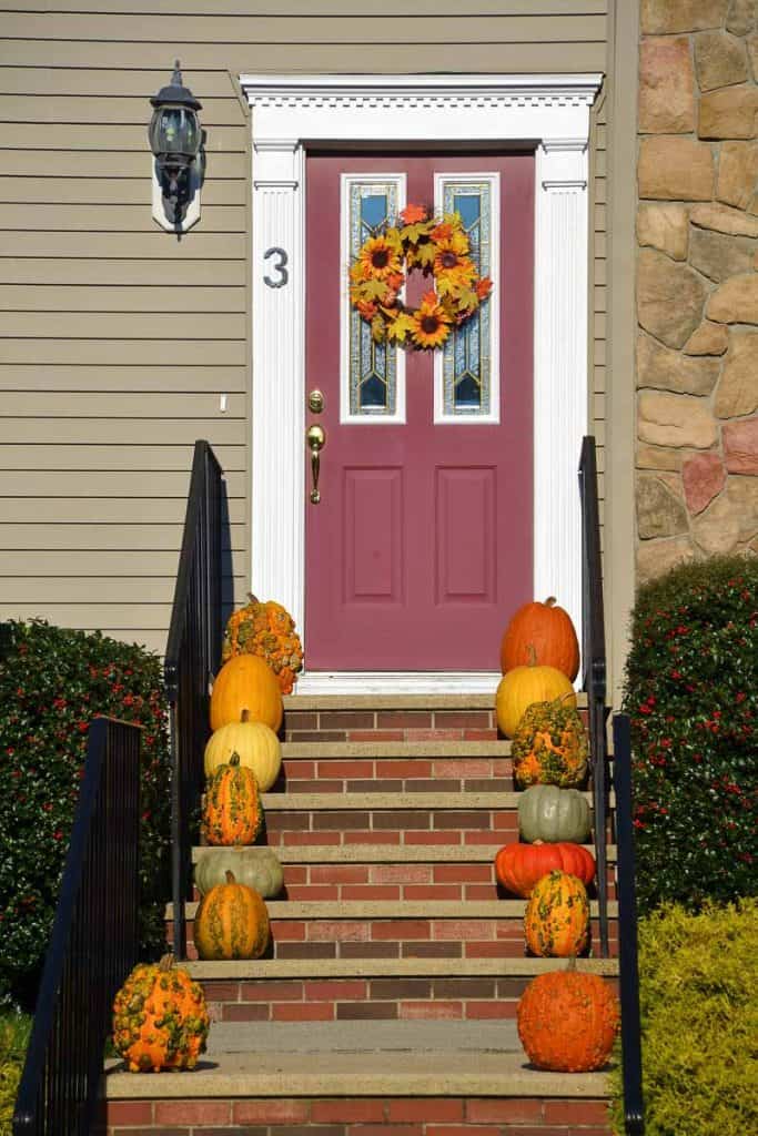 FALL SHOWCASE An assortment of interesting pumpkins including _Warty Goblin_ line the front steps at the home of Betty Couture in Lynnhurst