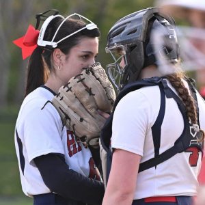 Danni-Hope Randall and Shayna Smith take a moment on the mound during their recent game against Everett.  (Advocate file photo)