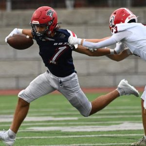 Pats running back Geo Woodard tries to escape a Masco tackler. (Advocate photos by Emily Harney)