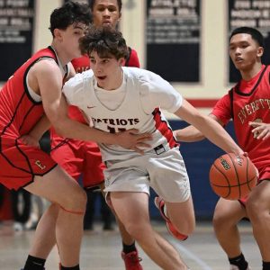 Revere’s Ethan Day drives the ball past an Everett guard during recent action.  (Advocate photo)