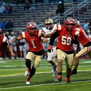 TD BOUND: Tide quarterback Tyler Freni heads to the end zone with some nifty blocking from John Barreiros and Enno Neto. (Advocate photo by Emily Harney)