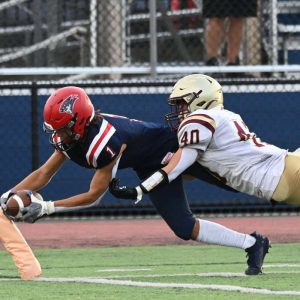 The Pats’ Geo Woodard dives into the endzone for Revere. (Advocate photos by Emily Harney)