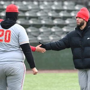 EHS Varsity Baseball Head Coach Malik Love congratulates his team for a hitless inning against Lynn Classical last season. (Advocate file photo)