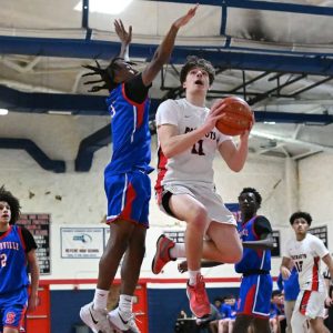 Co-Capt. Ethan Day avoids the block to score for the Patriots.