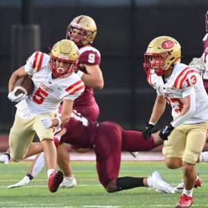 Everett’s running back Gideon Legall carries the ball for some yardage.