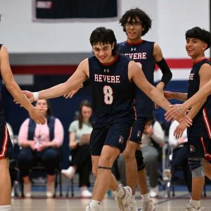 3.	Captain Ruben Rodrigues is congratulated by his teammates after scoring for the Patriots. The Pats boys volleyball team shutout the Lynn English Bulldogs, 3-0 on Wednesday.  (Advocate photo by Emily Harney)