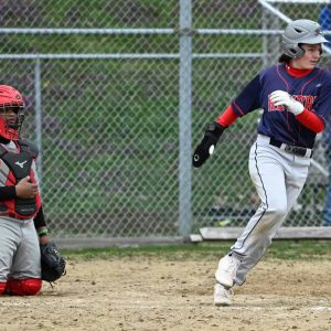 Revere’s Dom Bellia crosses home plate during recent action against Chelsea.  (Advocate file photo)
