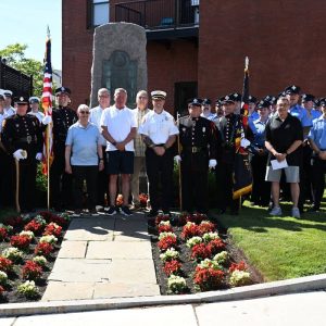 13.	Members of the Everett Fire Dept., past and present, gather in front of the Firefighters Memorial located in front of the Ferry St. Fire Station.