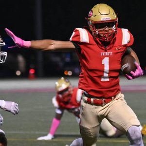 Everett’s Joao Barreiros is ready to stiff arm a Taunton defender.