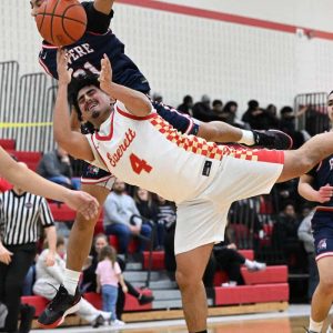 Tide senior captain Adam Aitmessaoud reaches for the ball off balance in recent action against Revere.  (Advocate file photo)
