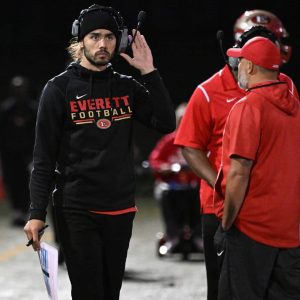 EHS Football Head Coach Justin Flores confers with his asst. coaches during last year’s GBL matchup against Somerville.  (Advocate file photo)