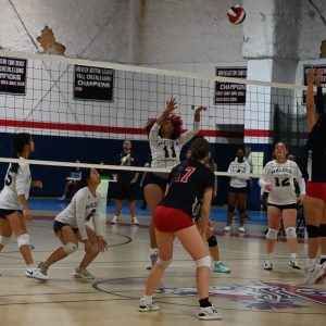 Players from the Malden volleyball team watch on after their teammate Vivienne Crawford #11 returns the ball during their game with Revere Wednesday.