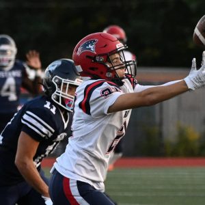 REACHING: Football Pats Zakaria Benkirane attempted a catch during their meeting with Medford at Hormel Stadium in Medford. (Advocate photo by Emily Harney)