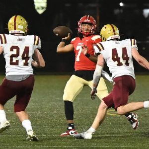 Everett quarterback Carlos Rodrigues looks for an opening to make a pass during last year’s comeback win over BC High, 35-34.  (Advocate file photo)