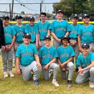 The Dolphins, pictured from left to right: front row: Jaxon Nickerson, Lorenzo Solis, Michael Menard and Ramon Ostolaza; back row: Coach Jay Nickerson, Chris Faria, James Melendez, Giovanni Cambriello, Dmitri Camell, Jacob Christie, Levi Kruckenberg, Nick Cook-Tran and Coach Ken Mazonson. (Courtesy photo)