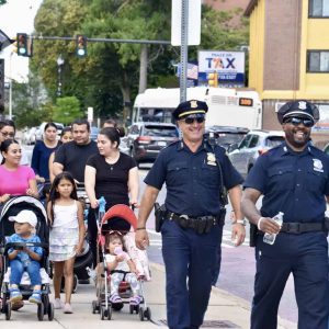 Residents joined with Everett police officers on Broadway as they walk to Everett Stadium.