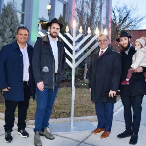 Gathering together to light the menorah, pictured from left to right: Everett Fire Chief Joseph Hickey, Mayor Carlo DeMaria, Rabbi Sruli Baron, Mayor-Elect Robert Van Campen and Tobin Bridge Chabad members.