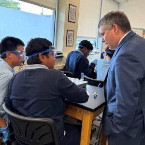 Senator Sal DiDomenico talking with Pioneer Charter School of Science students about their class.