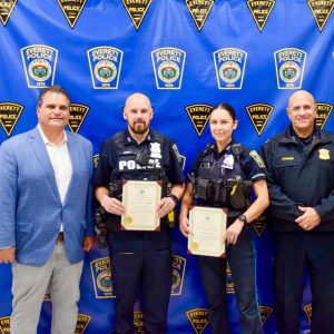 Police Officers Justin Poirier and Rachael Hall holding Citations presented by Mayor Carlo DeMaria (left) along with Police Chief Paul Strong (right).