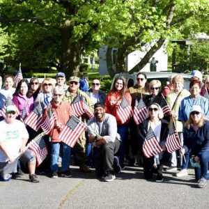 Many volunteers gathered in support of the City of Everett’s effort to place U.S. flags at the graves of veterans at Woodlawn Cemetery.