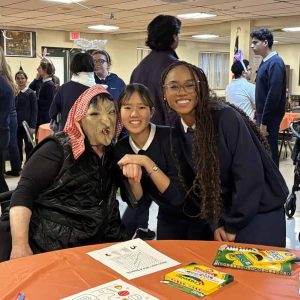 Beverly Cargill in costume with MVRCS students Yukino Inomata of Malden and Robensline “Liline” Seide of Saugus (Courtesy photo)