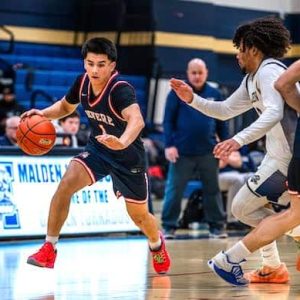 Revere’s Chris Recino (1) dribbles up court against Malden. (Advocate Photos/Henry Huang)