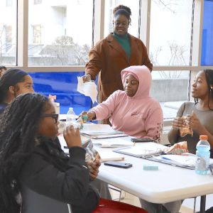 WorkSmart coordinator Cassandra LeBrun talks with Malden High students involved with the program. (Courtesy/Blue and Gold/Beatriz Oliveira Photo)