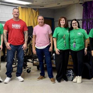 Assistant Director of Youth Substance Use Prevention Eric Mazzeo and Addiction Recovery Resource Specialist Paul Guarino alongside school staff.