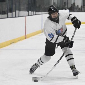 Saugus/Peabody hockey player Dom Chianca moved the puck up the ice during recent action against Marblehead. (Advocate photo by Emily Harney)
