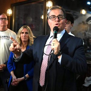 Just minutes after the unofficial results were announced in the Everett mayoral race, winner Robert Van Campen addressed the crowd of supporters who gathered at the Village Bar & Grill to celebrate his election victory, with his wife, Lisa, and campaign manager Chris Connolly by his side. (Advocate photo by Emily Harney)