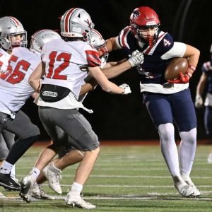 6.	Gabe Paretsis with the ball for Revere, works his way past a group of Wakefield defensemen.