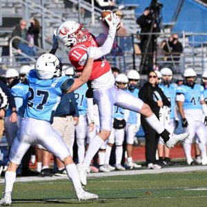 UP & OVER: Sachem co-captain Isaiah Rodriguez makes a nifty catch over a Tanner defender during Saugus’ Thanksgiving Day battle at Veteran’s Memorial Stadium in Peabody. (Advocate photo by Emily Harney)