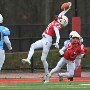 5.	Sophomore Pharoah Brandenburg leaps for the ball near the endzone.