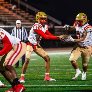 Everett QB Vesselin Therault (#10) hands the ball off to running back Kevin Diaz (#7) during the Tide’s blowout win over Lynn Classical.  (Advocate photo)