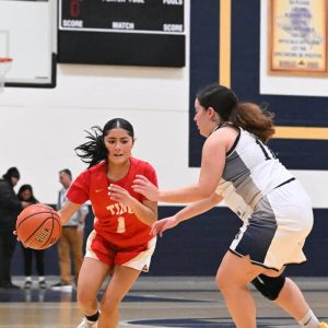 Lady Tide’s Sonia Flores drove the ball up court during recent action against Malden.