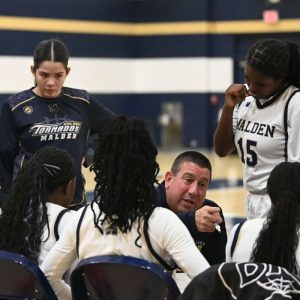 1.	Malden Head Coach Scott Marino goes over the next play with his team during their game Tuesday night.