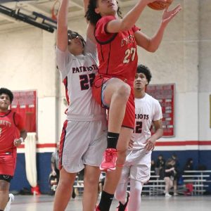 11.	Geordiell Luna Morales goes up for the basket as a Revere player works to block the basket attempt. (Advocate Photo by Emily Harney)