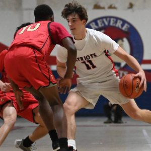 3.	Patriot Captain Ethan Day looks to make a play against Everett guards.