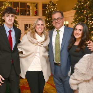 Robert Van Campen and his wife Lisa stand with their son, John and daughter, Lily, at the holiday event.