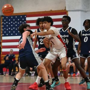 Patriots senior center Amir Yamani had a terrific double-double performance with 10 points versus Lynnfield. Amir is shown battling Medford defenders in a recent matchup in Revere. (Advocate file photo)