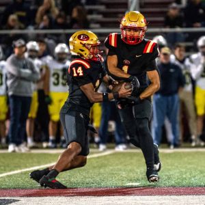 Tide QB Carlos Rodrigues hands off to running back Joao Barreiros during action against Xaverian.  (Advocate file photo)