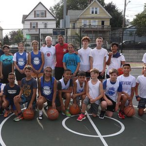 John McCarrick with Coach John Leone and the new blood of Revere’s blacktop basketball players. Leone has taken up the torch from “Ace” McCarrick’s lead and is instrumental in Revere youth sports programs.  (Advocate photo)