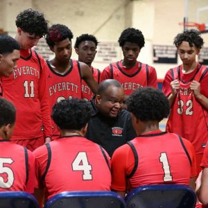 Everett Head Coach Gerald Boyce takes a timeout with his team during the season opener last season against Revere.  (Advocate file photo)
